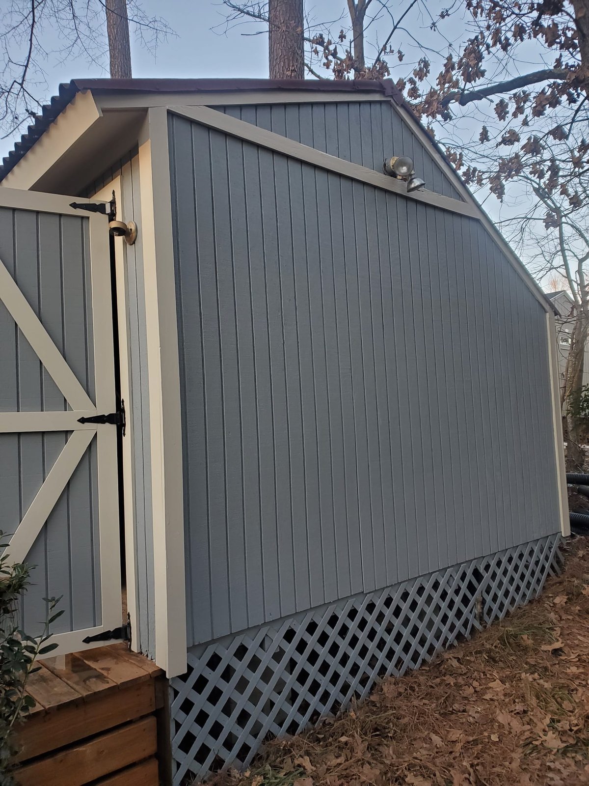 Gray-painted outbuilding with white-trim doors — Lou's Atlanta Painting