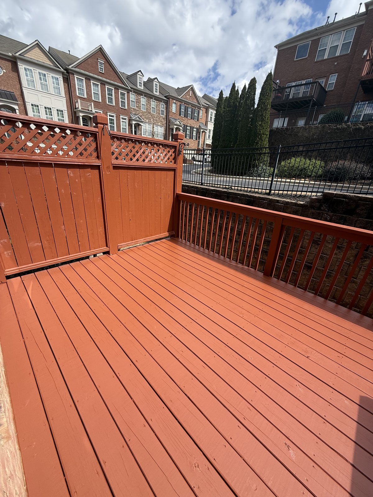 Bold red-terracotta painted second-story deck — deck refinishing by Lou's Atlanta Painting