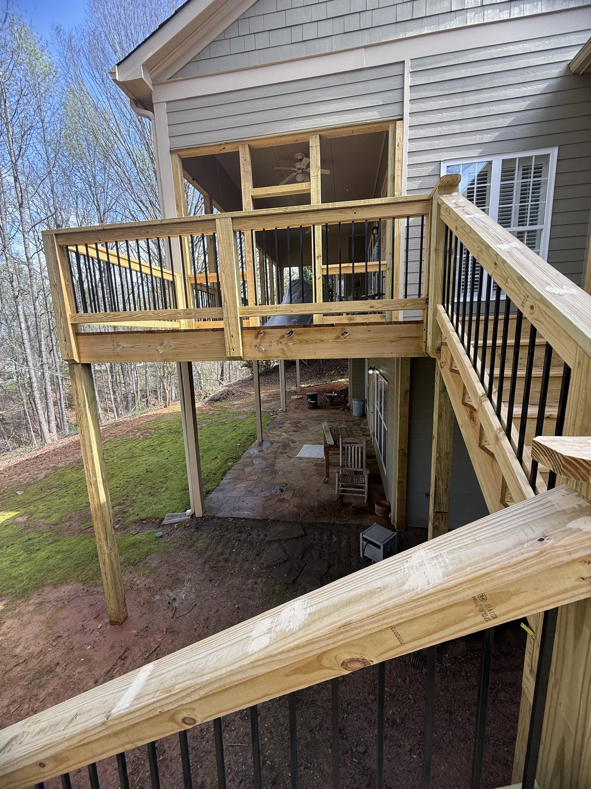 Newly built wooden deck with elevated platform and railing — Lou's Atlanta Painting