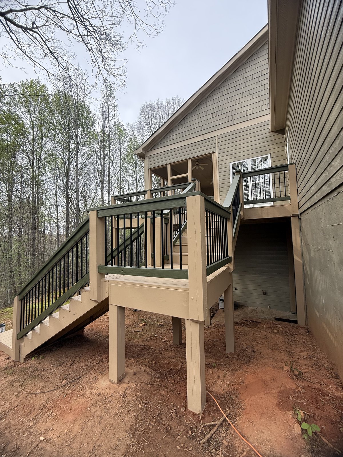 Multi-level tan-stained deck with stairs and railing — Lou's Atlanta Painting