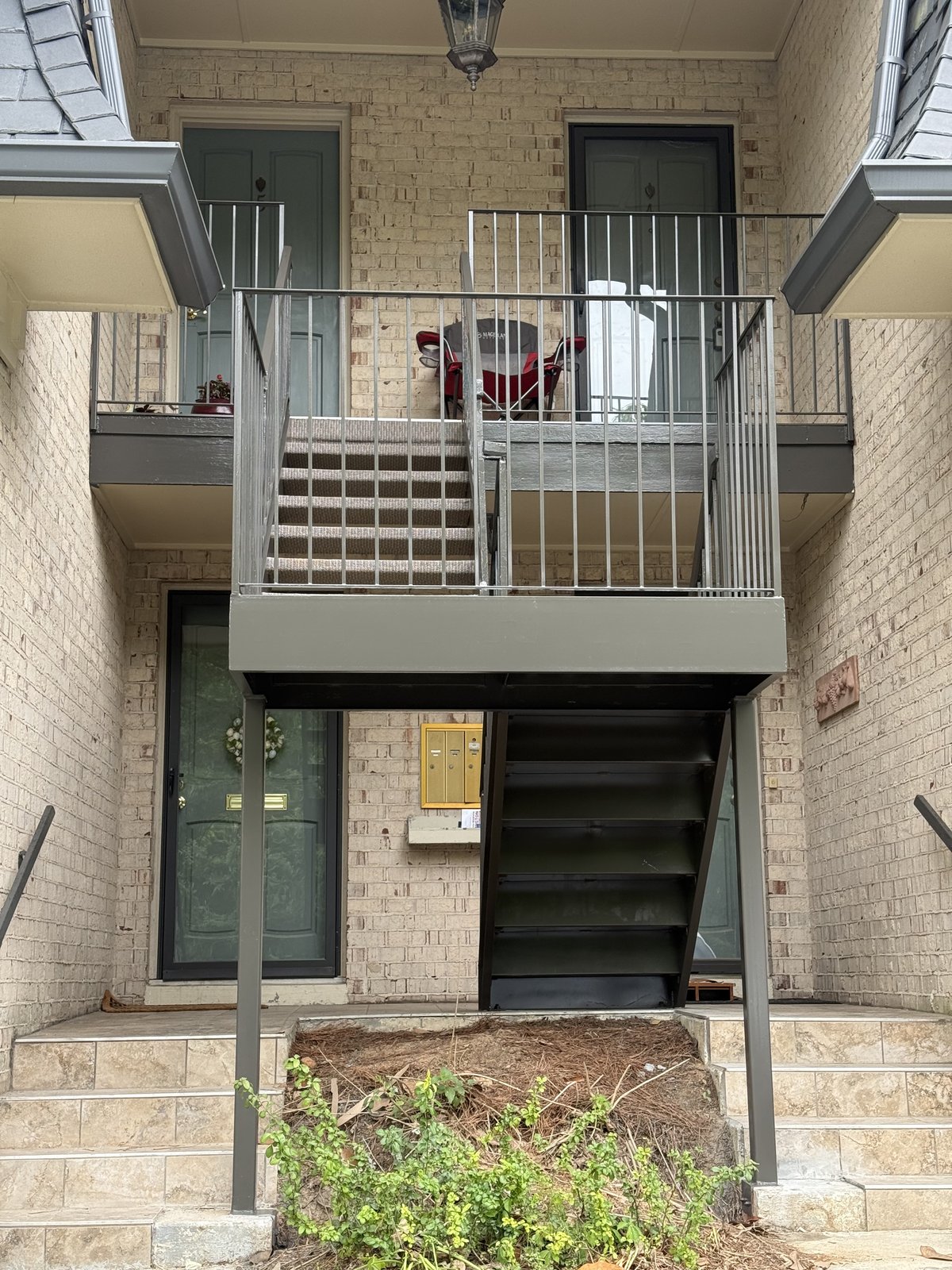 Painted exterior stairwell and railing at a multi-unit property — Lou's Atlanta Painting