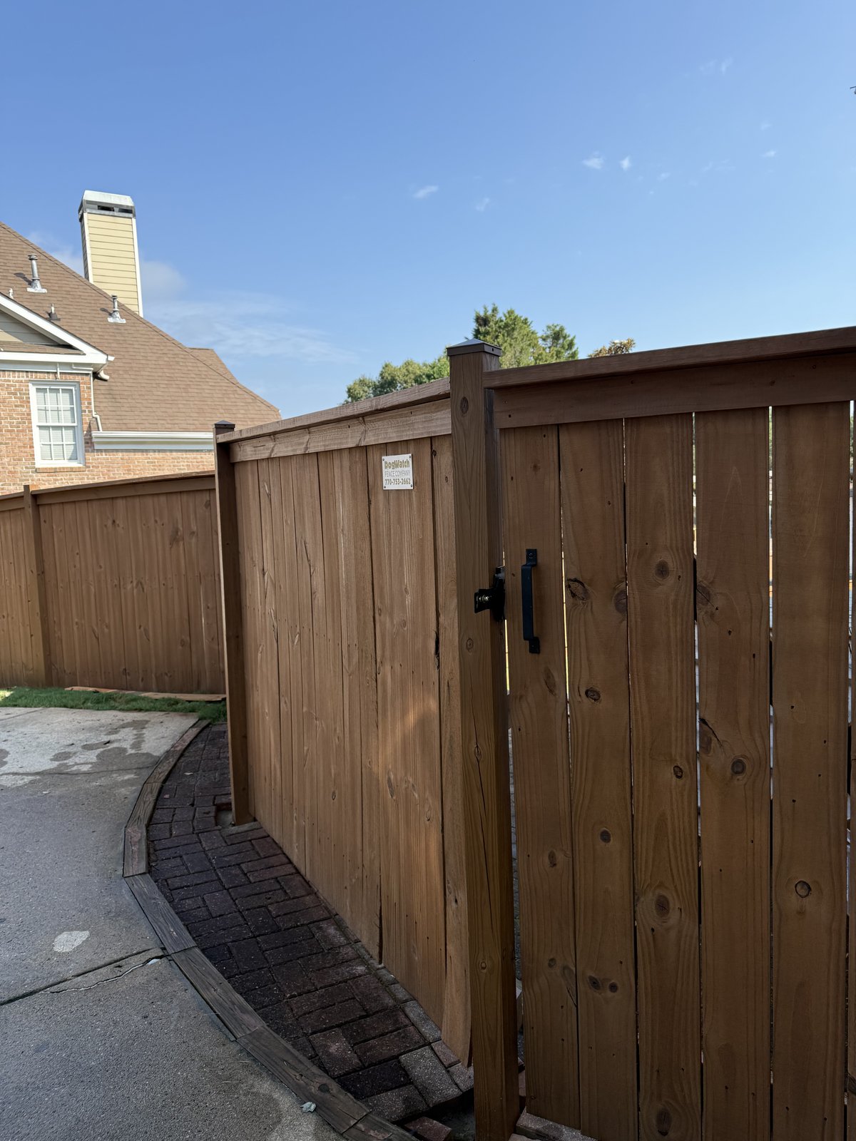 Natural-wood privacy fence with a hinged gate — Lou's Atlanta Painting