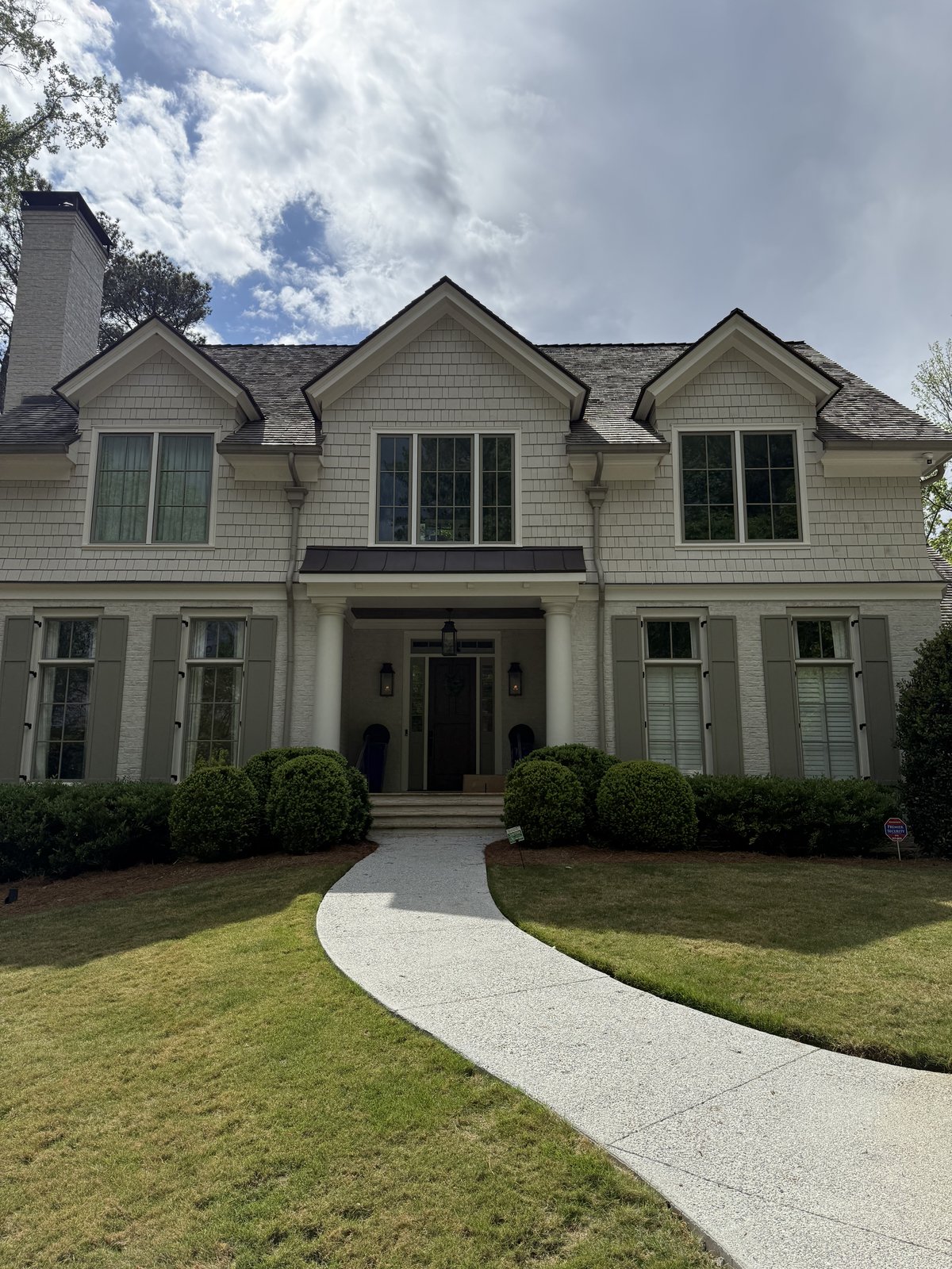 Two-story home with deep navy siding and crisp white trim — Lou's Atlanta Painting