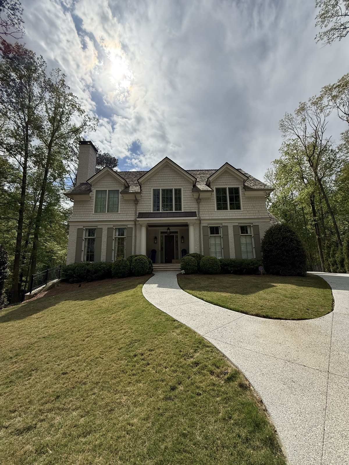 Cream two-story traditional home with red front door — exterior repaint by Lou's Atlanta Painting