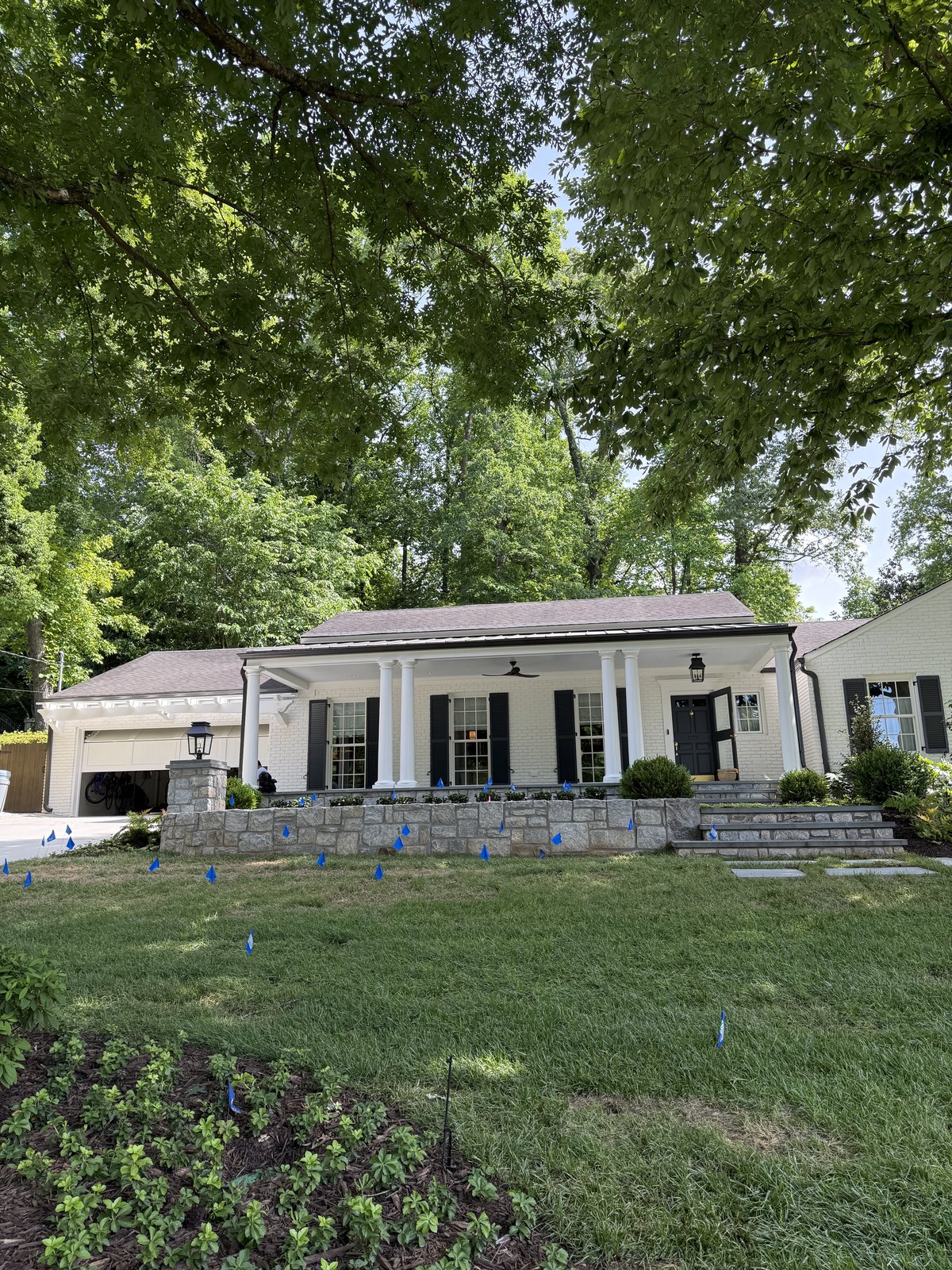 Front entry with a navy door, white trim, and brick steps — Lou's Atlanta Painting