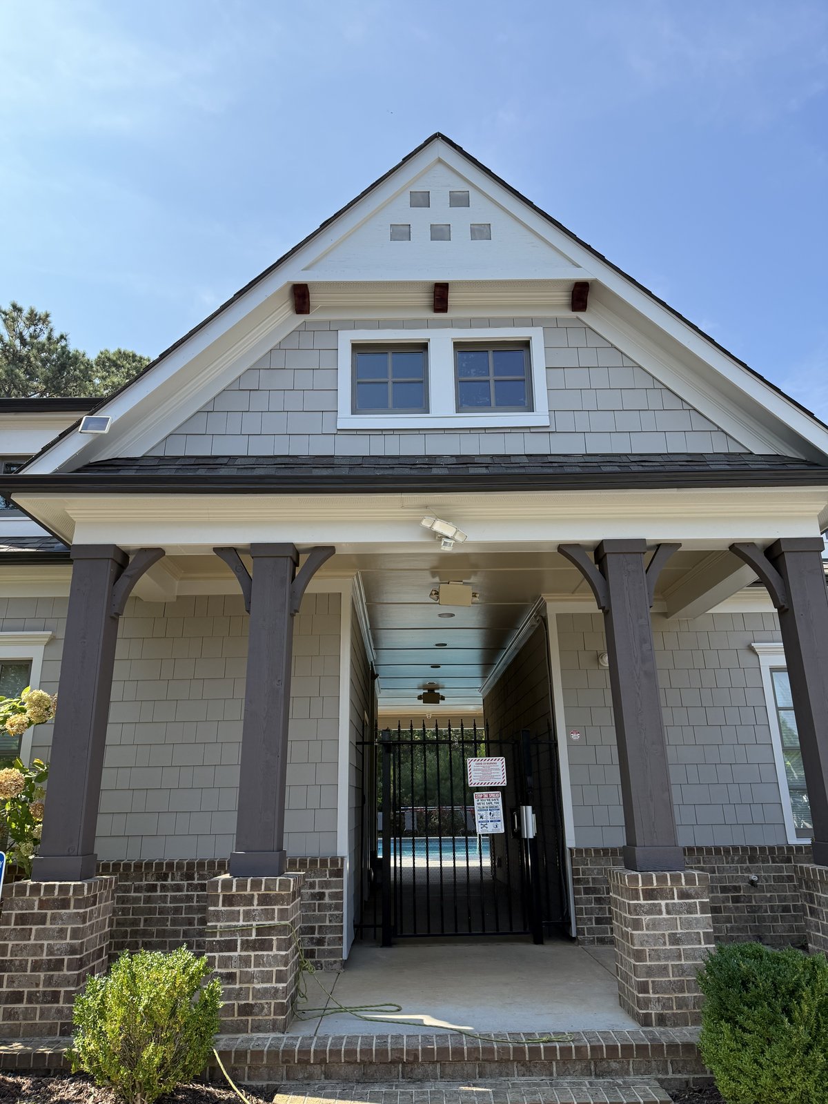 Light blue-gray craftsman home with white trim and covered porch — Lou's Atlanta Painting