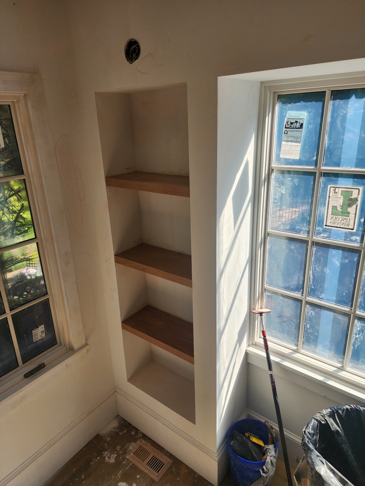 Bright entryway with a modern staircase in white and dark accents — Lou's Atlanta Painting
