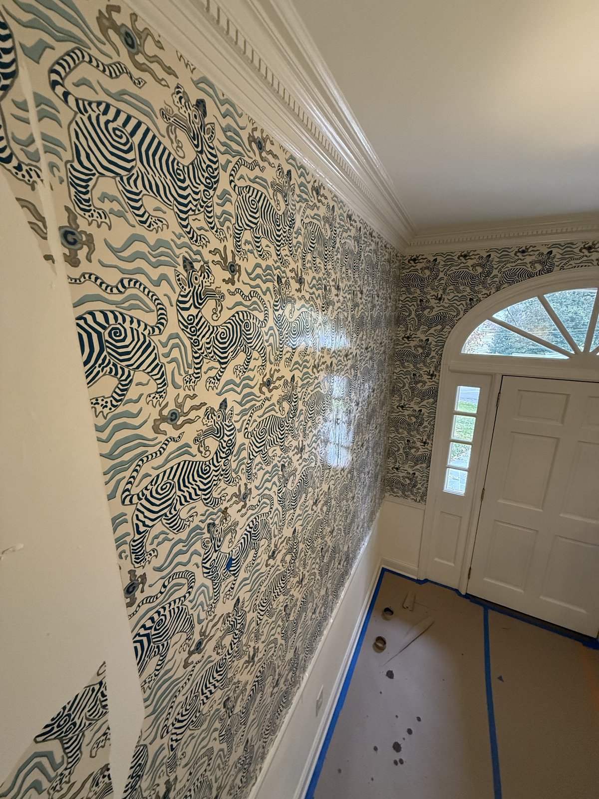 Entryway with a bold blue-and-cream patterned wall treatment — Lou's Atlanta Painting