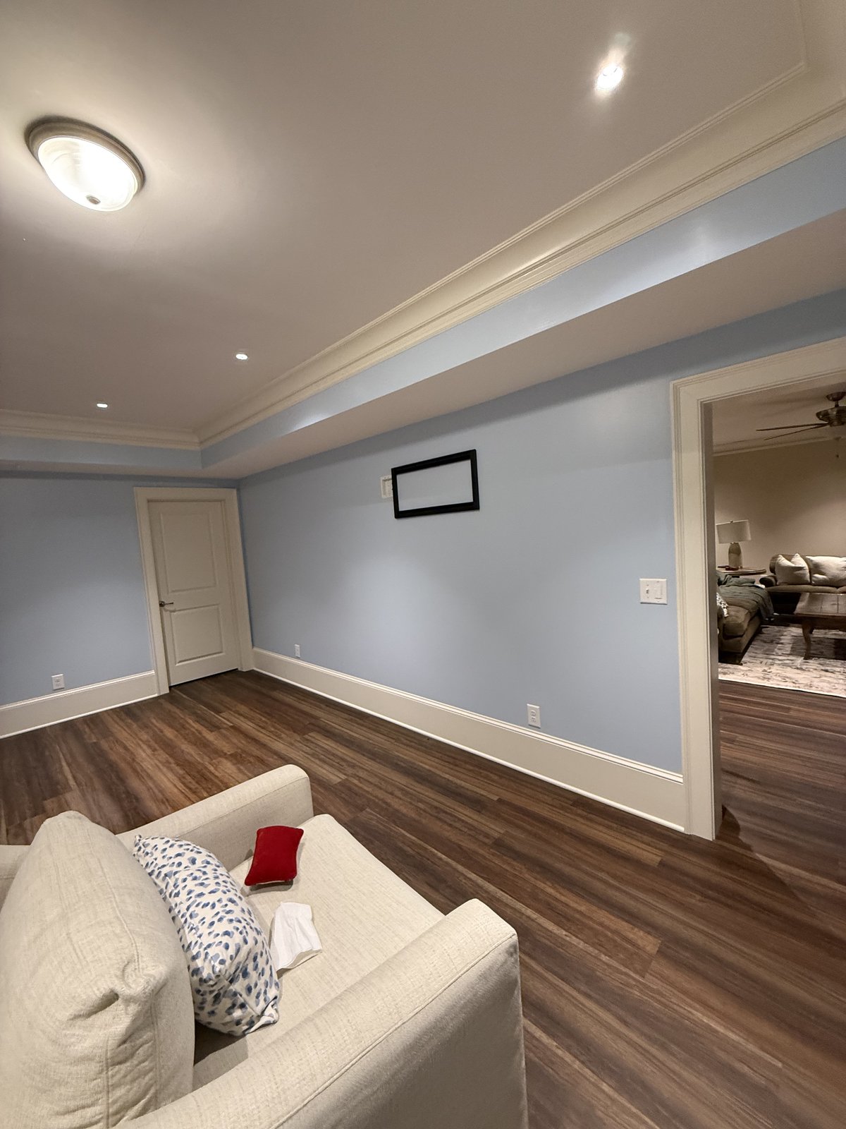 Open living room with light beige walls and dark hardwood floors — Lou's Atlanta Painting
