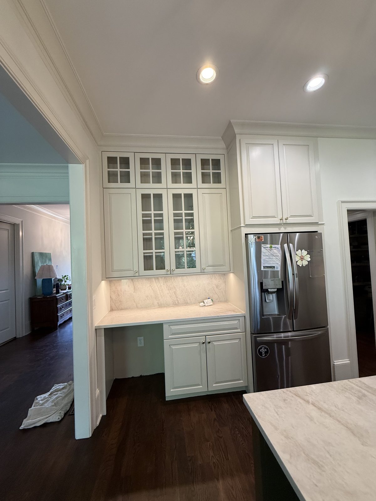 Butler's pantry with refinished glass-front cabinets in soft white and a marble desk surface — Lou's Atlanta Painting